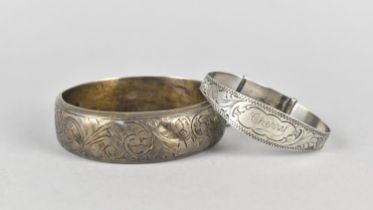 A Silver Bangle with Chased Floral Decoration, Birmingham Hallmark together with as Silver