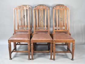 A Set of Six Oak Framed Dining Chairs with Leather Pad Seats