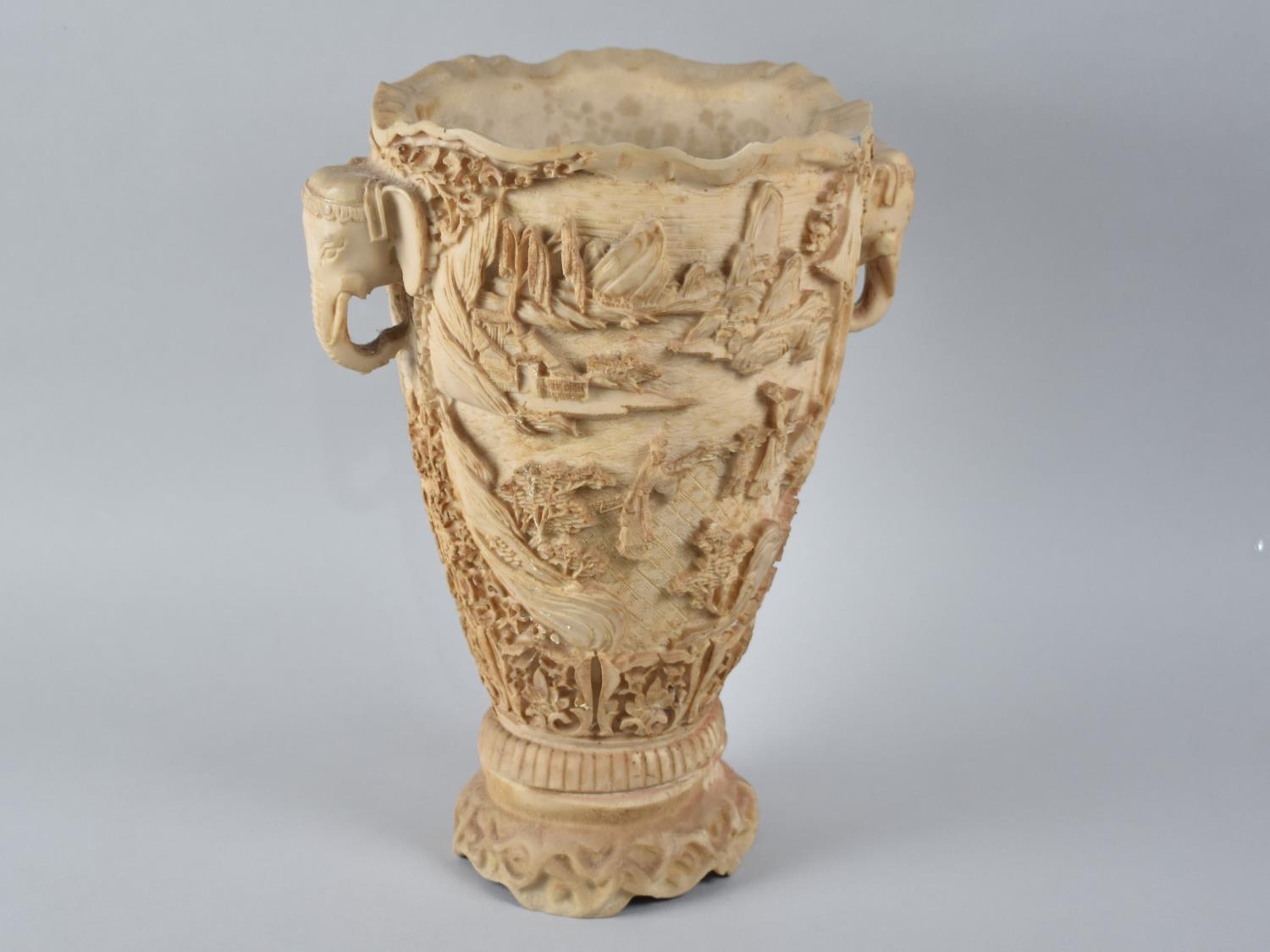 A Chinese Style Faux Ivory Vase decorated in Relief with Figures in Exterior Setting having Twin