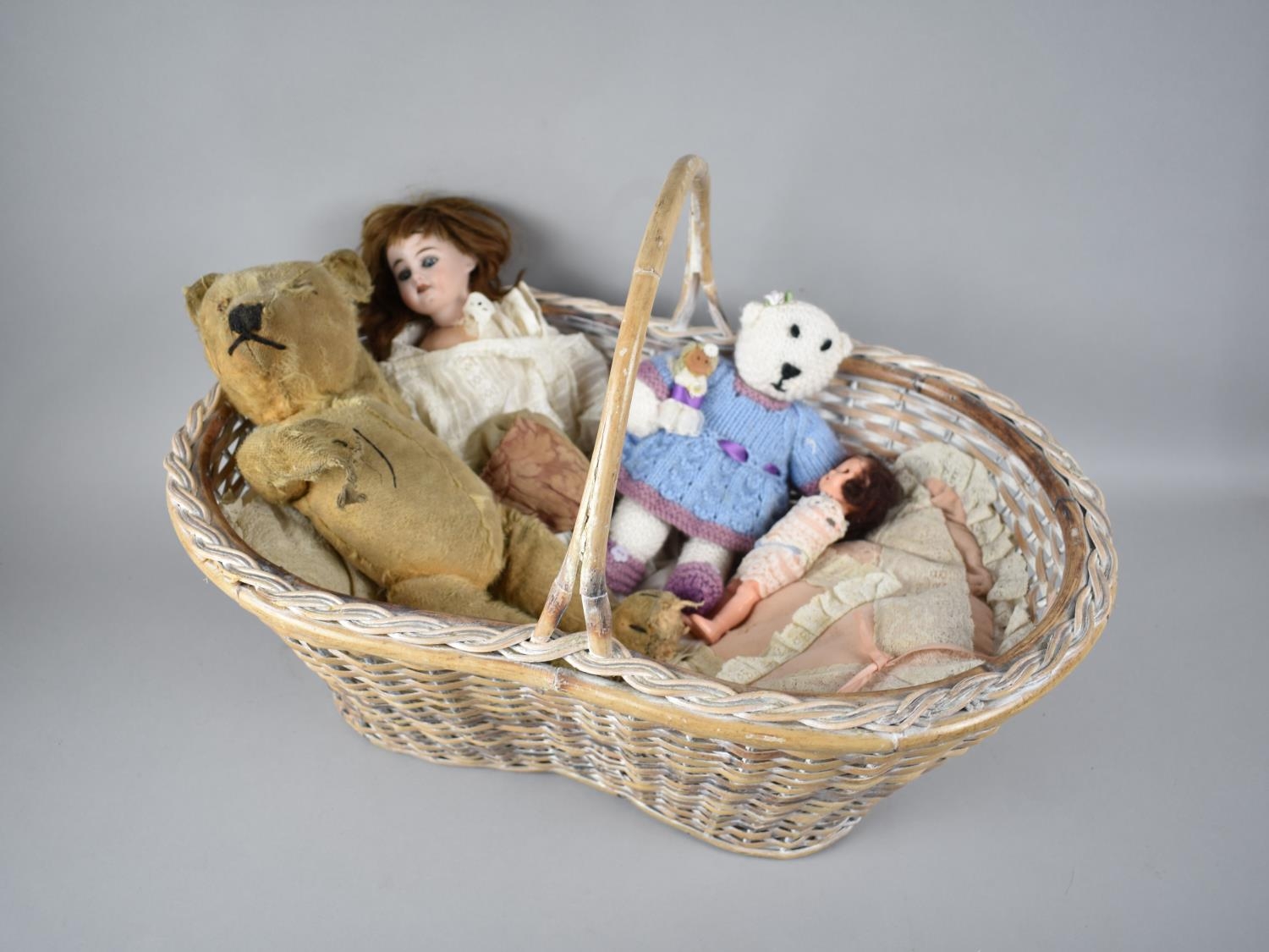 A Wicker Basket Containing Vintage Plush Teddy Bear, Porcelain Head French Doll Etc, Condition
