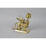 A 19th Century Heavy Brass Candlestick in the form of the Winged Lion of St. Mark in Venice, 13.5cms