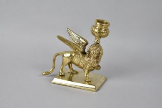 A 19th Century Heavy Brass Candlestick in the form of the Winged Lion of St. Mark in Venice, 13.5cms