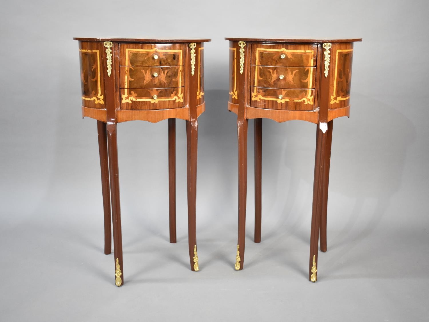 A Pair of Reproduction French Style Ormolu Mounted Inlaid Three Drawer Oval Side Cabinets on
