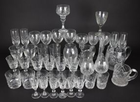 A Large Collection of Various Drinking Glasses to Comprise Champagne Flutes, Wines, Tumblers etc