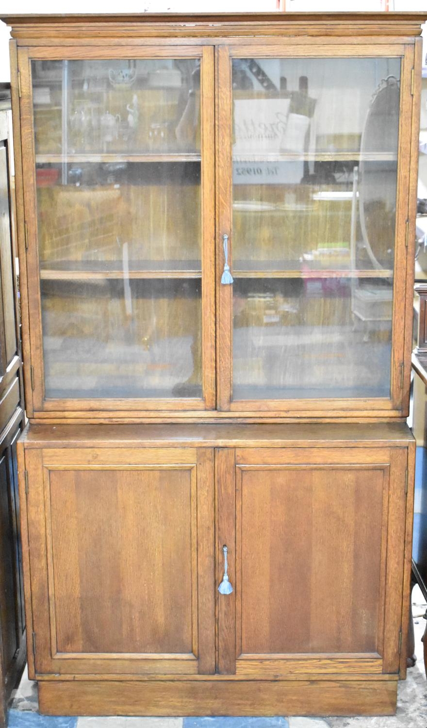 An Edwardian Oak Glazed Bookcase with Cupboard Base, 106cms Wide