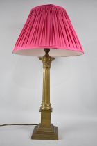 A Brass Table Lamp in the From of a Reeded Corinthian Column on Stepped Square Base, Complete with