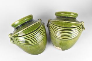 A Pair of Green Glazed Stoneware Planters in the Form of Buried Amphora Vases, 26cms Wide