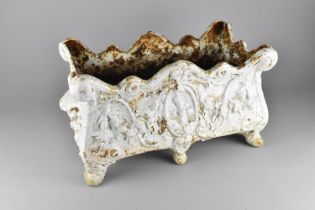 A White Painted Cast Iron Planter of Rectangular Form Decorated in Relief on Short Scrolled