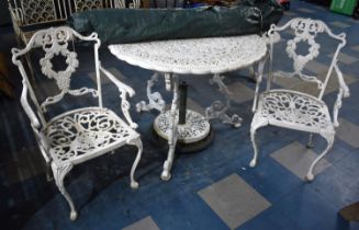 A Set of Four White Painted Cast Metal Chairs Together with a White Painted Cast Metal Table and a