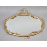 An Edwardian Oval Wall Hanging Gilt Framed Mirror with Floral Swag and Ribbon Decoration,