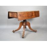 A 19th Century Mahogany Drop Leaf Table on Splayed Quadrant Reeded Supports Culminating in Paw Feet,