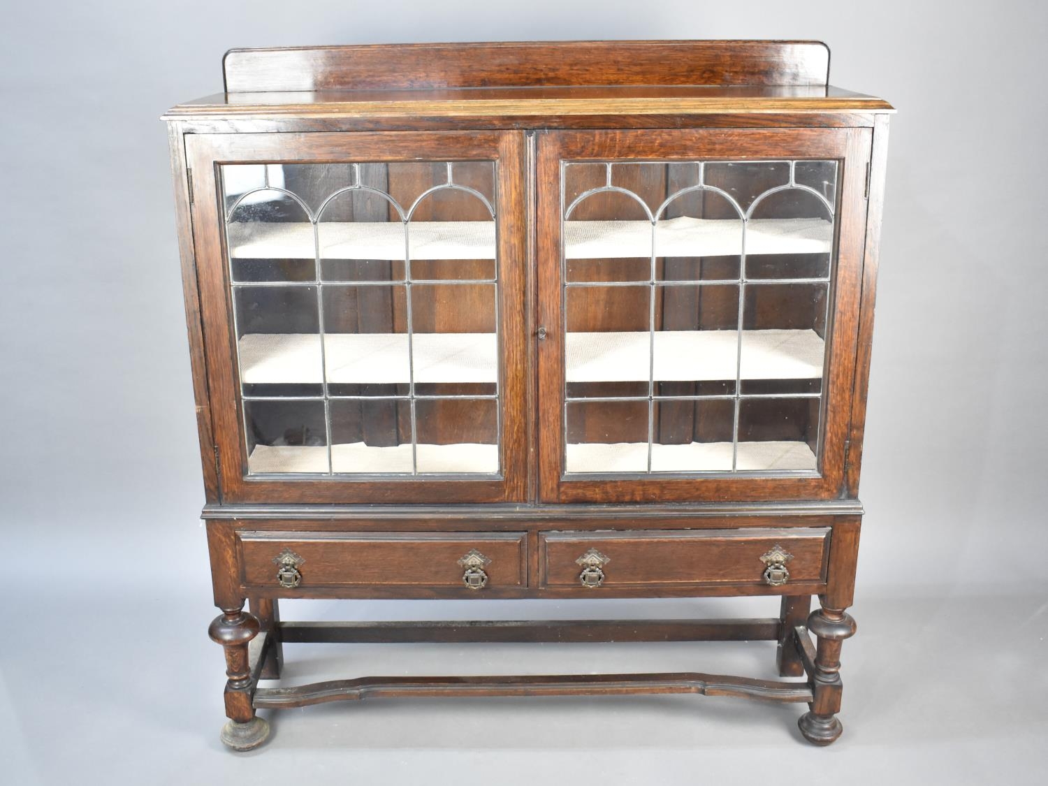 An Edwardian Galleried Display Cabinet with Two Base Drawers, Leaded Glazed Doors, 107cms Wide