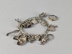 A Silver Charm Bracelet with Various Charms to include Coracle, Bible, Ice Skater, Wedding Bells Etc