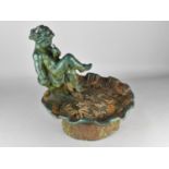 A Cast Metal Figural Bird Bath Modelled With Cherub Seated Upon Lily Pad on Short Circular Foot,