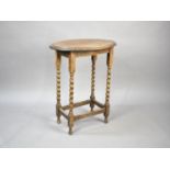 An Edwardian Oak Oval Topped Occasional Table with Barley Twist Supports, 57cms Long