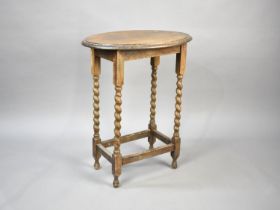 An Edwardian Oak Oval Topped Occasional Table with Barley Twist Supports, 57cms Long