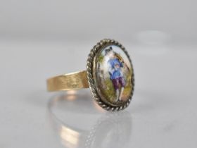 An 18ct Gold Ring, Central Porcelain Plaque Depicting Musician in White Metal to a Plain Polished