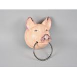A Modern Cast Iron Wall Mounting Towel Ring in the From of a Pigs Head, 17cms High plus VAT