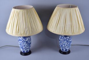 A Pair of Oriental Blue and White Ceramic Vase Shaped Table Lamps, with Shades, 49cms High