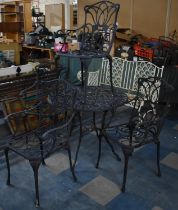 A Black Painted Cast Metal Garden Patio Set to Comprise Four Chairs and Table