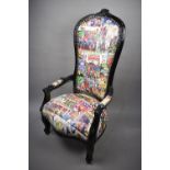 A Reproduction Black Painted Nursing Armchair Upholstered in Marvel Comic Printed Fabric