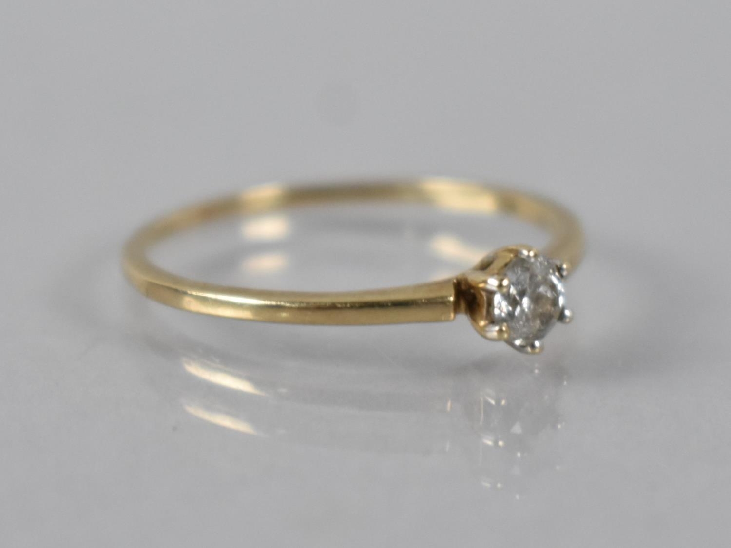 A 9ct Gold Mounted Diamond Ring, Round Cut Stone Measuring 3.7mm in Six Claws to a Delicate 9ct Gold