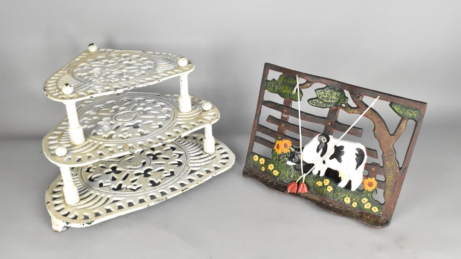 A White Painted Cast Metal Three Tier Pan Stand Together with a Cast Metal Recipe Holder with Cow