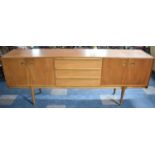 A 1970s McIntosh Teak Sideboard with Three Centre Drawers Flanked by Cupboards Either Side, 213cms