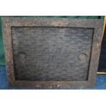 A Heavy Cast Metal Manhole Cover and Frame, 71x57