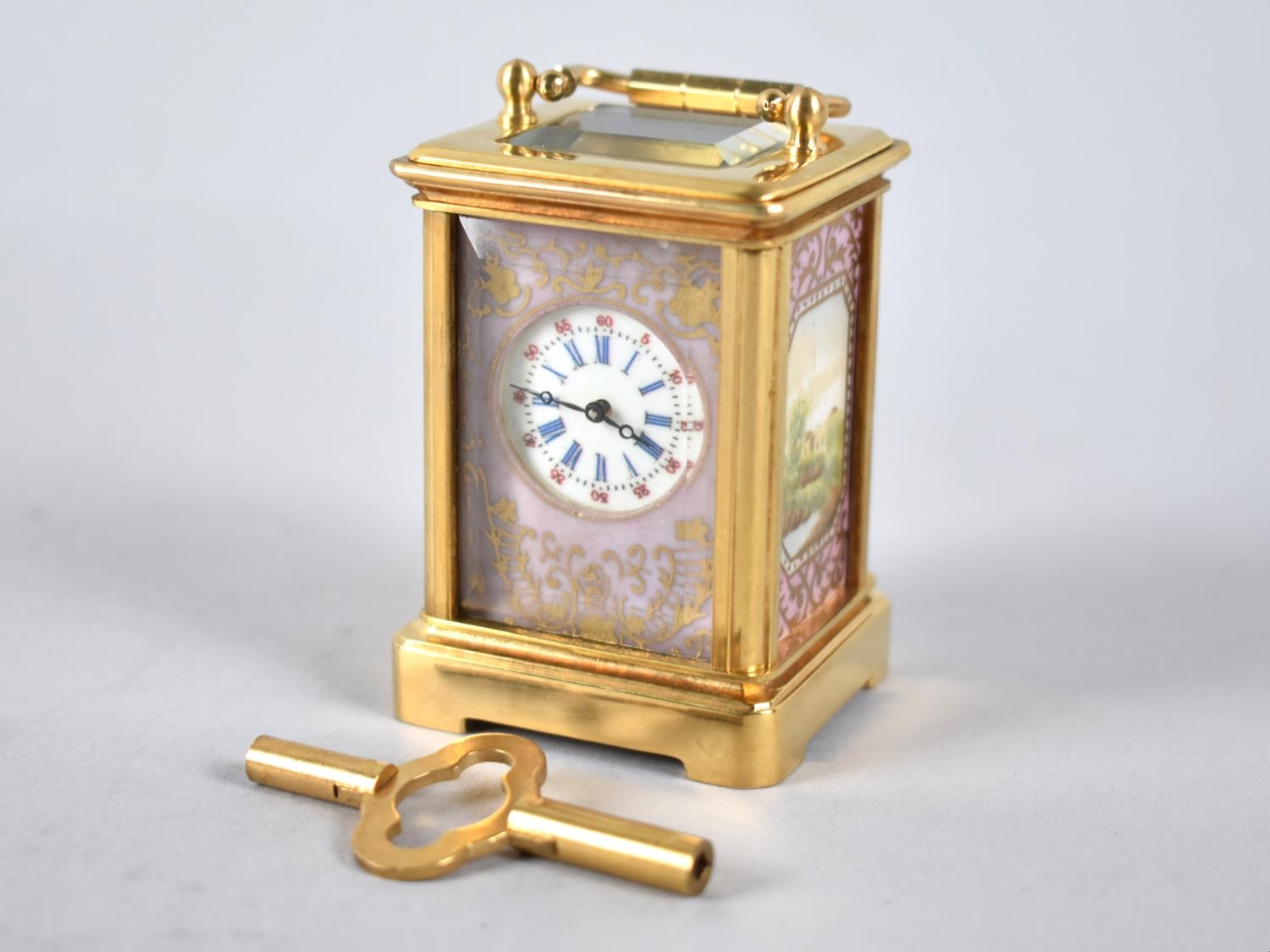 A Miniature Reproduction Sevres Style Carriage Clock with Gilt Brass Case and Pink and Gilt