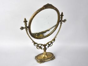 A Mid 20th Century Brass Swing Oval Toilet Mirror, 47cms High