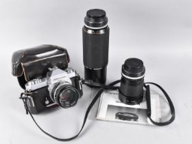 A Nikkormat 35mm Camera together with Two Nikkor Lens together with a Zoom Lens