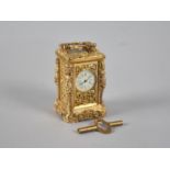 A Reproduction Ornate Gilt Brass Miniature Carriage Clock with White Enamelled Dial, Complete with