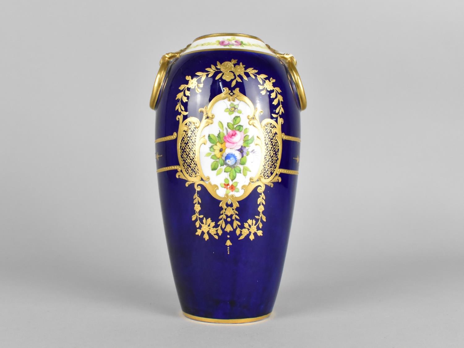 A Mintons Vase Decorated with Hand Painted Floral Cartouches on Blue Ground with Gilt Detailing, the