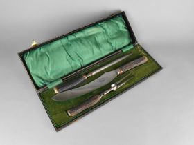 A Cased Three Piece Carving Set with Antler Handles