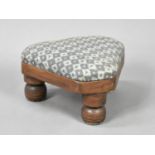 A Modern Triangular Upholstered Footstool with Turned Supports, 27cms Long