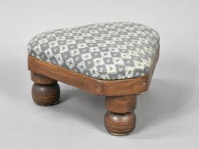 A Modern Triangular Upholstered Footstool with Turned Supports, 27cms Long