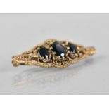 A 9ct Gold and Sapphire Brooch, Central Oval Cut Stone Measuring 7.9x6.1mm, Raised in Ten Claws to a