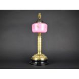 A Late Victorian Brass Based Oil Lamp with Pink Opaque Glass Reservoir Decorated with Flowers,