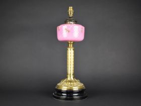 A Late Victorian Brass Based Oil Lamp with Pink Opaque Glass Reservoir Decorated with Flowers,