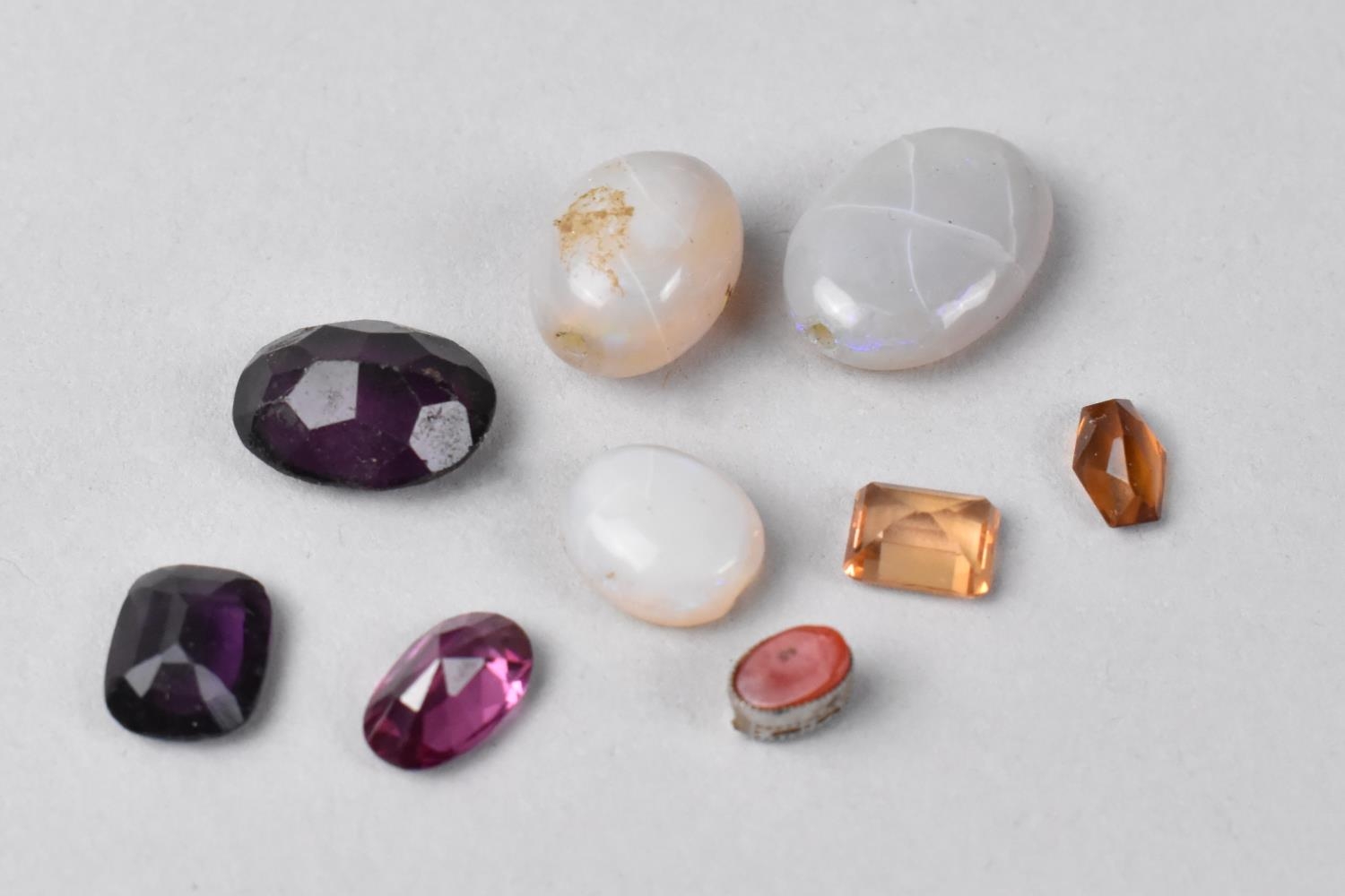 A Collection of Various Cut Stones to include Amethyst and Citrine types together with Three Opal