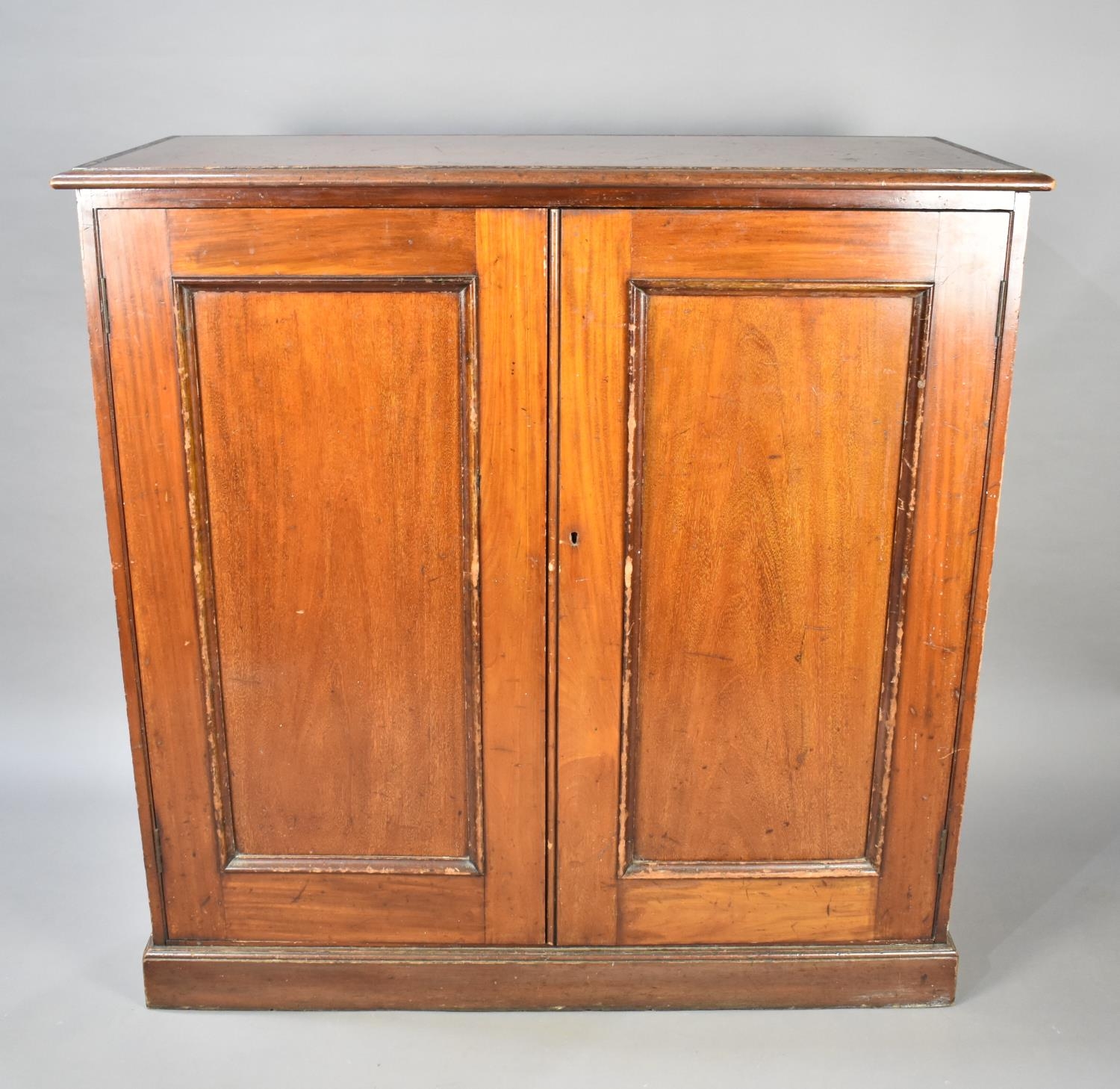 A Late Victorian/Edwardian Mahogany Side Cabinet With Panelled Doors wot Shelved Interior, 111cms