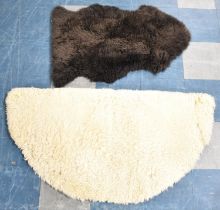 A Demi Lune Sheepskin Hearth Rug and a Black Sheepskin Rug