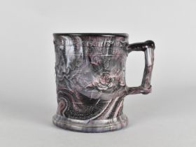 A 19th Century Slag Glass Mug with Relief Decoration, 9.5cm high
