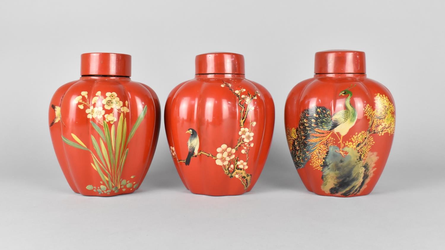 A Set of Three Oriental Lacquered Lidded Lobed Ginger Jars Decorated with Flowers, Insects and