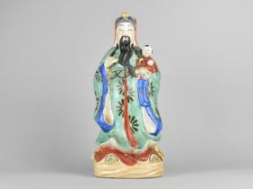 A Chinese Porcelain Study of Deity Holding Child, 39cms High