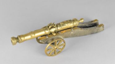 A Mid 20th Century Brass and Wooden Model of a Continental Cannon, 35cms Long