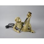 A Modern Novelty Table Lamp Base in the Form of a Reclining Monkey, 35cms Long