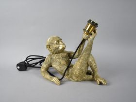 A Modern Novelty Table Lamp Base in the Form of a Reclining Monkey, 35cms Long