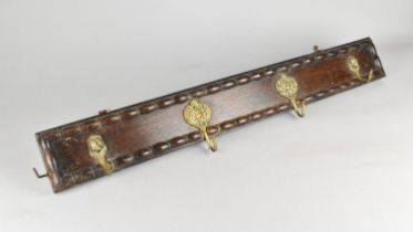 An Early 20th Century Oak Coat Rail with Four Brass Coat Hooks, 75cms by 10cms